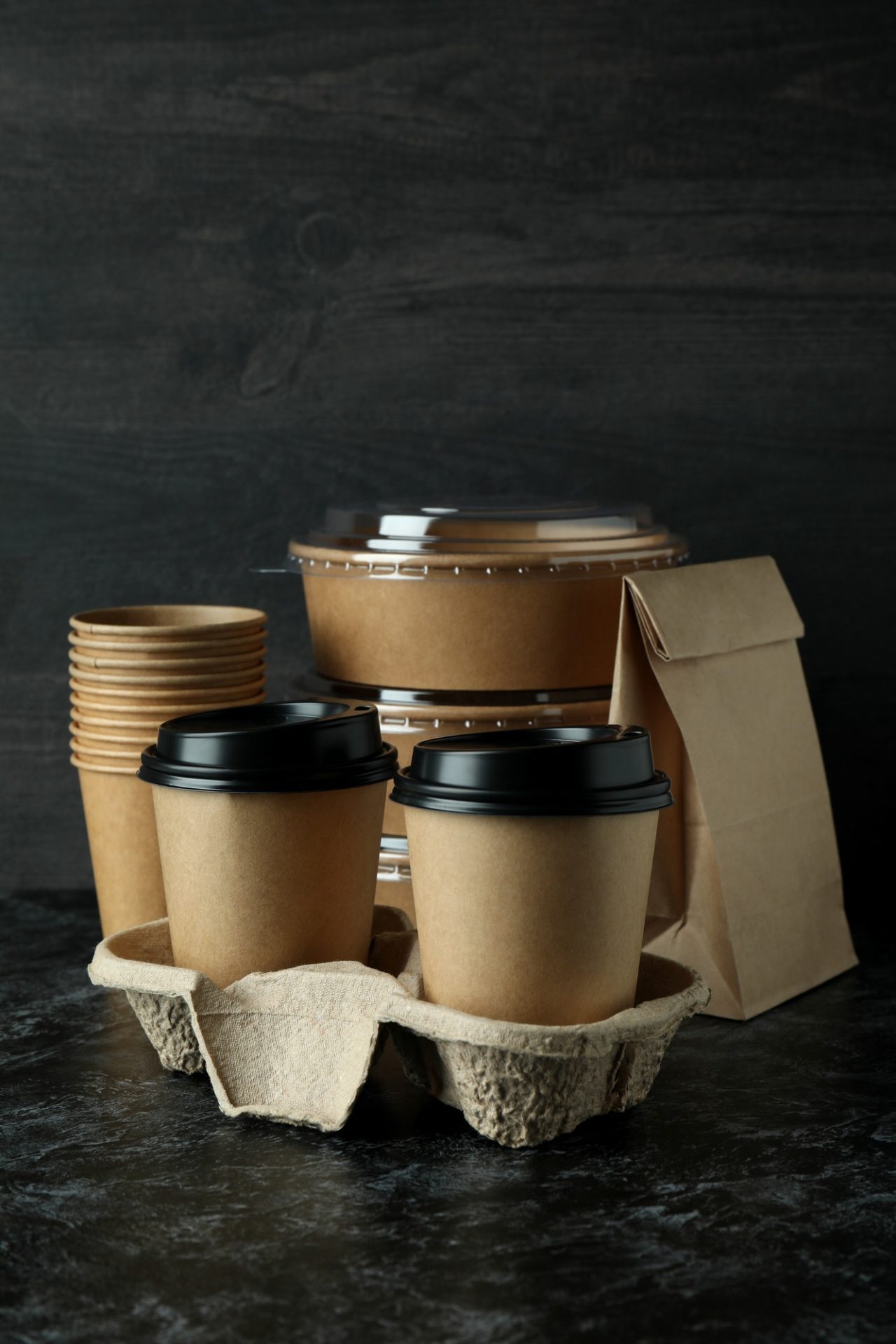 Delivery containers for takeaway food on black smokey table