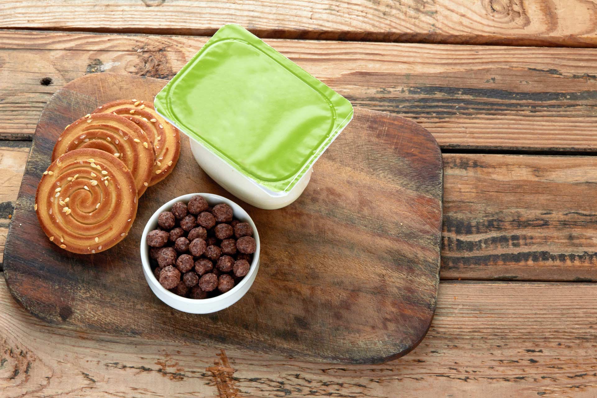 Fruit yogurt on wooden serface with biscuits